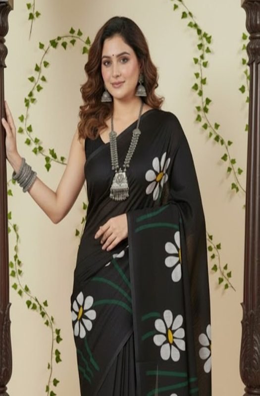 Woman draping a soft black mul saree with handpainted white daisy flowers, showing lightweight and breathable texture perfect for office wear front view draped on model by swamini sarees
