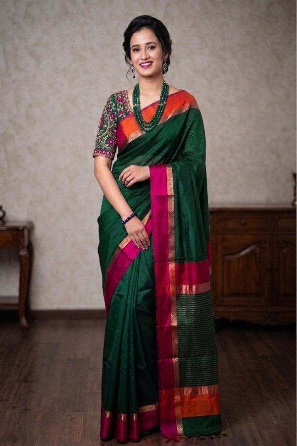 green maheshwari cotton silk ganga jamuna border front view draped on model by swamini sarees