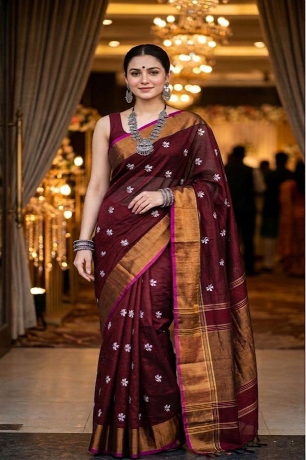 maroon parijat prajakta flower embroidery bronze golden border saree draped on model front view by swamini sarees